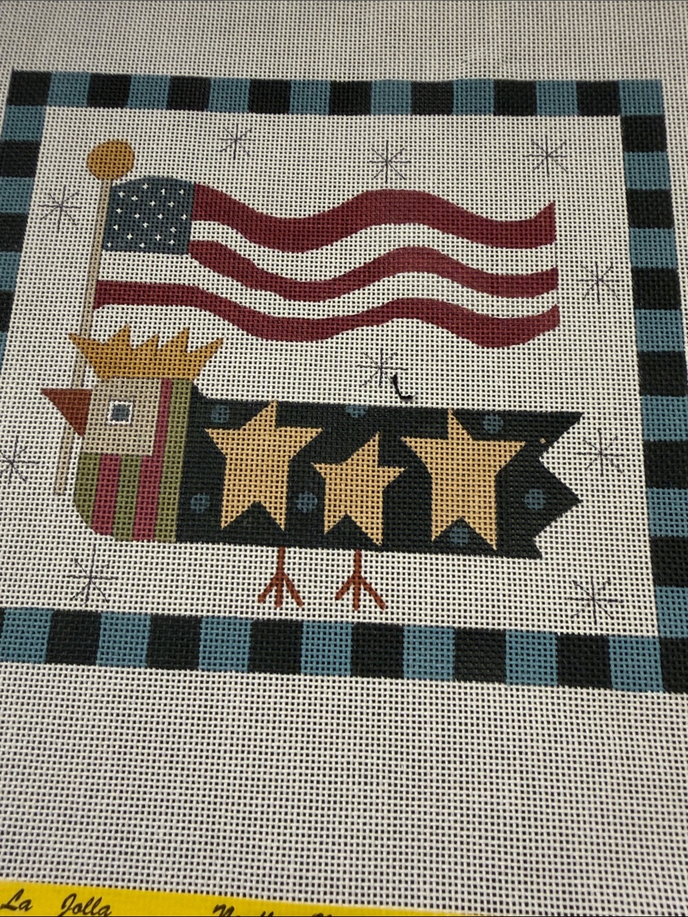 needlepoint canvas features a stylized bird American flag banner and stars.🐈‍⬛